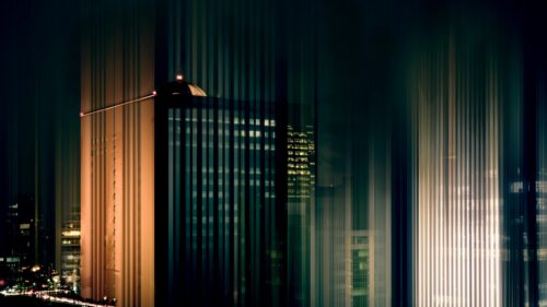Abstract Night Cityscape with Vertical Light Streaks 4K Wallpaper