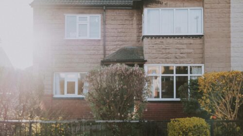 Cozy Suburban Home with Spring Blossoms Desktop Wallpaper