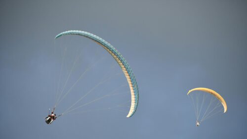 Two Paragliders Soaring in Clear Blue Sky Desktop Wallpaper