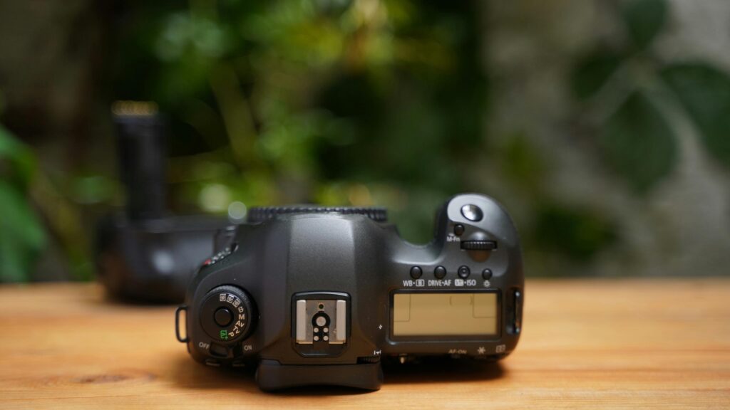 Professional Canon DSLR Camera on Wooden Table 4K Wallpaper