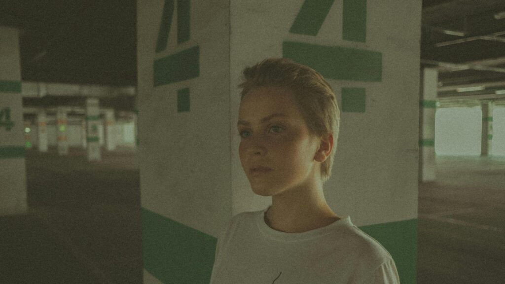 Short Hair Girl in Concrete Parking Garage Cinematic Desktop Wallpaper