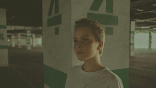 Short Hair Girl in Concrete Parking Garage Cinematic Desktop Wallpaper