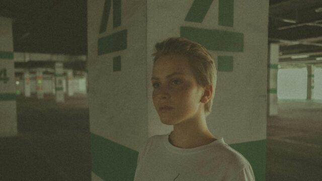 Short Hair Girl in Concrete Parking Garage Cinematic Desktop Wallpaper