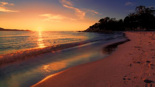 Stunning Golden Hour Tropical Beach Sunset with Calm Waves Desktop Wallpaper