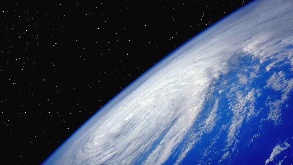Stunning Earth Horizon View from Space with Swirling Clouds 4K Wallpaper