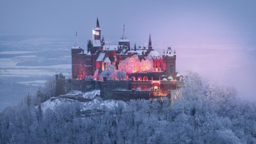 Hohenzollern Castle Winter Snowfall Illuminated at Dusk 4K Desktop Wallpaper