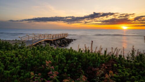 Serene Wooden Pier at Sunset over the Sea Desktop Wallpaper