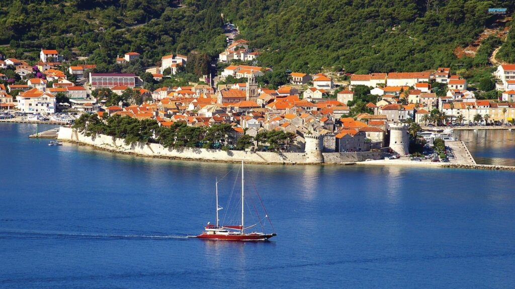 Beautiful Coastal Town of Korcula in Croatia with Sailing Yacht 4K Wallpaper