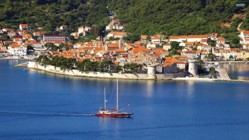 Beautiful Coastal Town of Korcula in Croatia with Sailing Yacht 4K Wallpaper