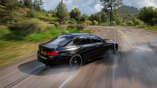 Black BMW M5 Drifting on Scenic Mountain Road 4K Wallpaper