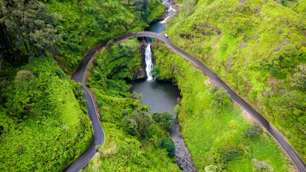 Aerial View of Scenic Road Over Waterfall and Tropical Forest PC Wallpaper