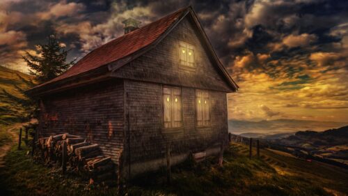 Cozy Wooden Cabin in Mountain Landscape at Sunset 4K Wallpaper