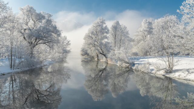 Stunning Winter Landscape with Frosted Trees and River Reflection 4K Wallpaper