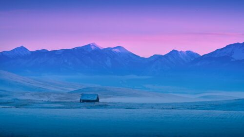 Lonely Barn in Snowy Mountains at Sunset Serene Landscape Desktop Wallpaper