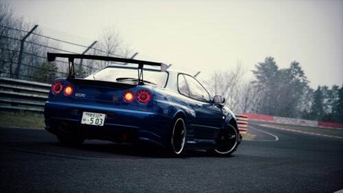 Blue Nissan Skyline GT-R R34 on Racetrack Desktop Wallpaper