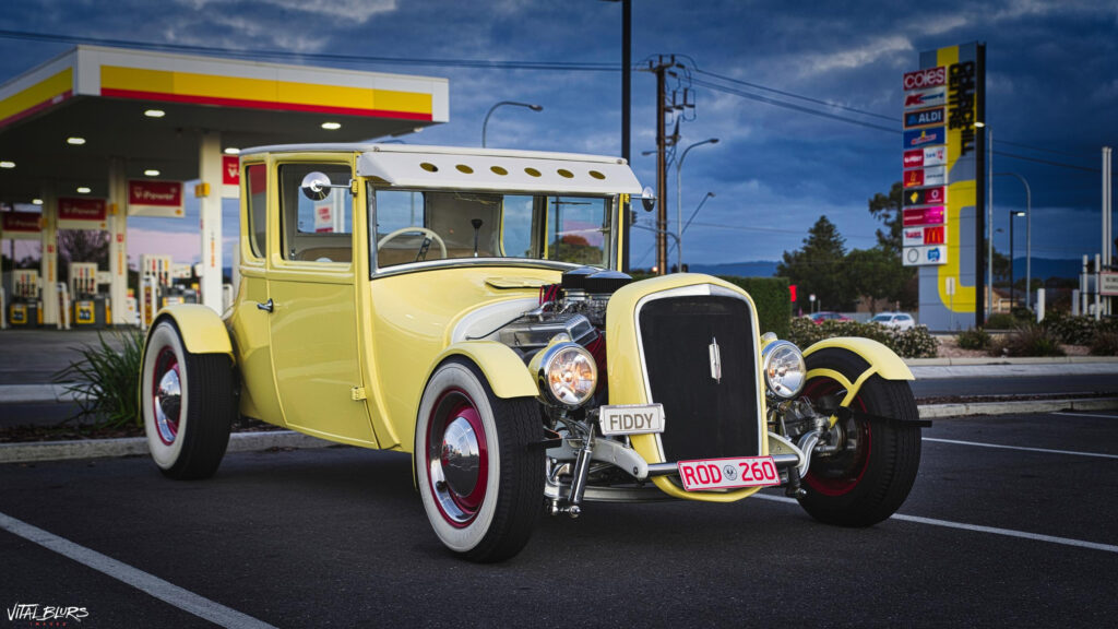 Stunning Classic Yellow Hot Rod at Twilight Gas Station Desktop Wallpaper