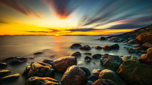 Stunning Long Exposure Sunset Over Rocky Shore 4K Desktop Wallpaper