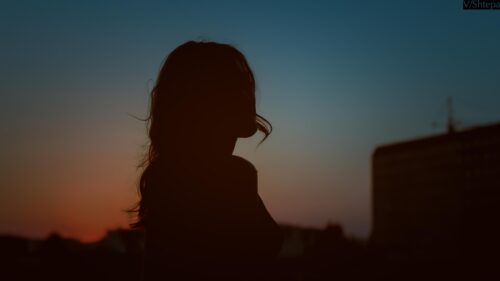 Stunning Silhouette of a Woman at Sunset Minimalist Desktop Wallpaper