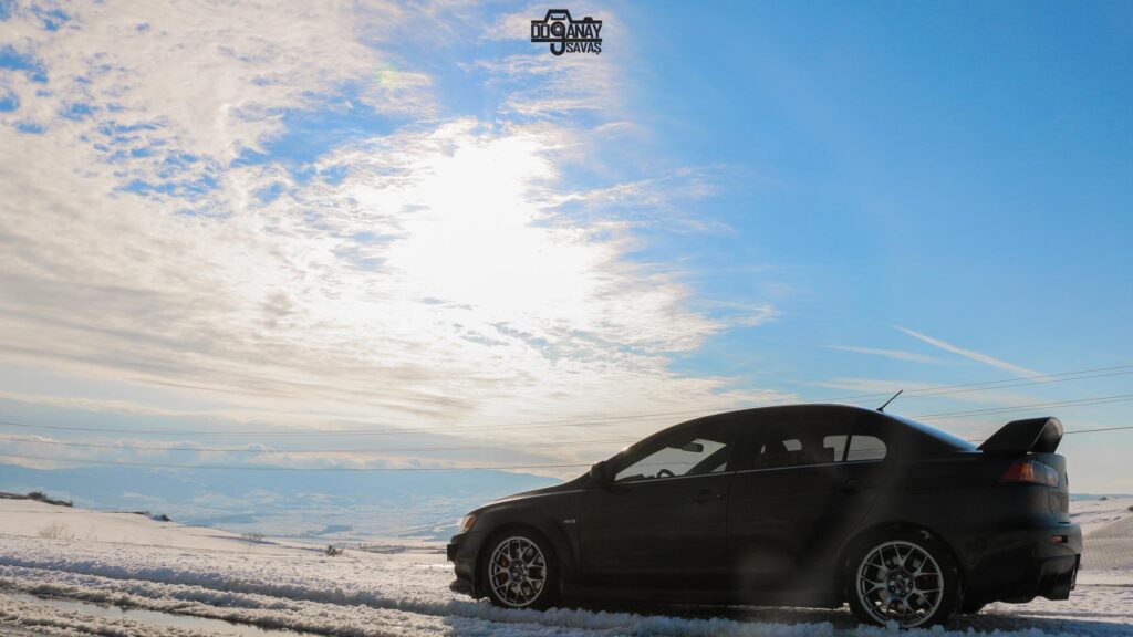 Black Mitsubishi Lancer Evolution in Snowy Winter Landscape 4K PC Wallpaper