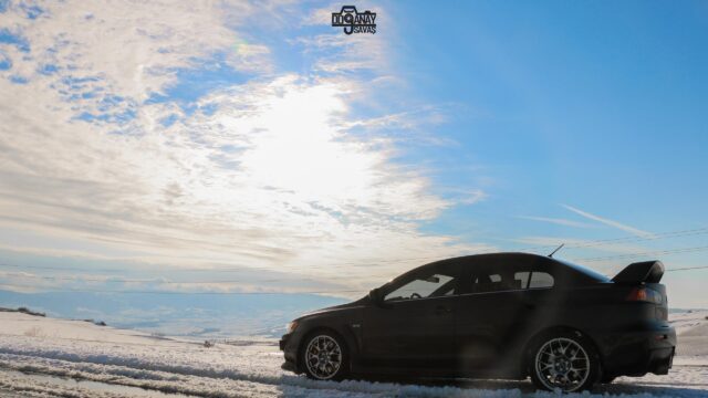 Black Mitsubishi Lancer Evolution in Snowy Winter Landscape 4K PC Wallpaper