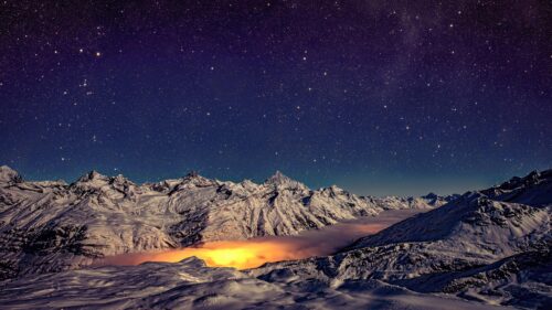 Stunning Snowy Mountain Range Under Night Sky 4K Desktop Wallpaper