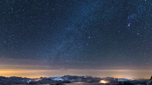 Breathtaking Night Sky over Snowy Mountain Peaks 4K Desktop Wallpaper