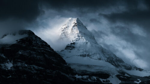 Dramatic Snowy Mountain Peak in Stormy Clouds 4K Desktop Wallpaper